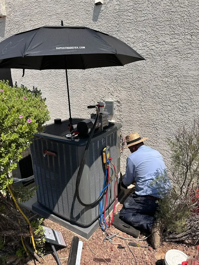 HVAC technician performing outdoor AC maintenance in Pickerington