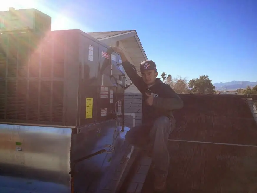 HVAC technician performing AC Tune-Up on a rooftop unit in Pickerington